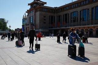 Beijing closes dozens of subway stations as Covid controls tighten
