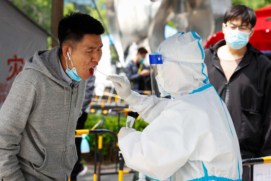 A man undergoes a COVID-19 test in Beijing, China, on May 9, 2022. MARK R. CRISTINO, EPA-EFE