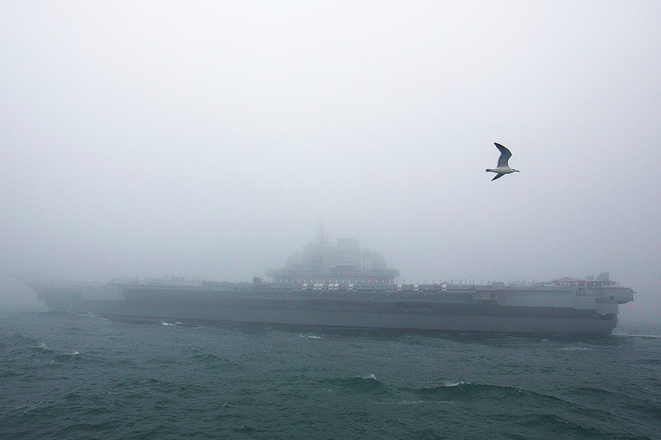 The Chinese People's Liberation Army (PLA) Navy aircraft carrier Liaoning participates in a naval parade to commemorate the 70th anniversary of the founding of China's PLA Navy in the sea near Qingdao, in eastern China's Shandong province on April 23, 2019. China celebrated the 70th anniversary of its navy by showing off its growing fleet in a sea parade featuring a brand new guided-missile destroyer. Mark Schiefelbein / POOL / AFP