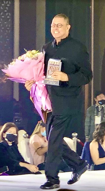 James Cooper receiving an award. Evelyn Alvaran. 