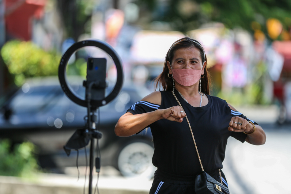 Swan Anding Meraluo dances in front of a mobile phone rig hoping that two performances a day for her TikTok account might hit a jackpot of likers. Jonathan Cellona, ABS-CBN News