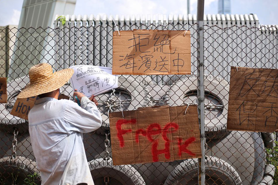 A worker removes protest materials  EPA-EFE/file