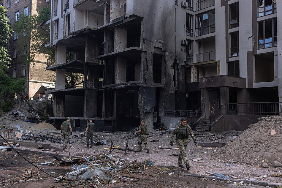 Ukrainian military members collect pieces of a missile on a site following Russian airstrikes in the Shevchenkivskiy district of Kyiv (Kiev), Ukraine, June 26, 2022. Multiple airstrikes hit the center of Kyiv in the morning. Russian troops on Feb. 24 entered Ukrainian territory, starting the conflict that has provoked destruction and a humanitarian crisis. Roman Pilipey, EPA-EFE