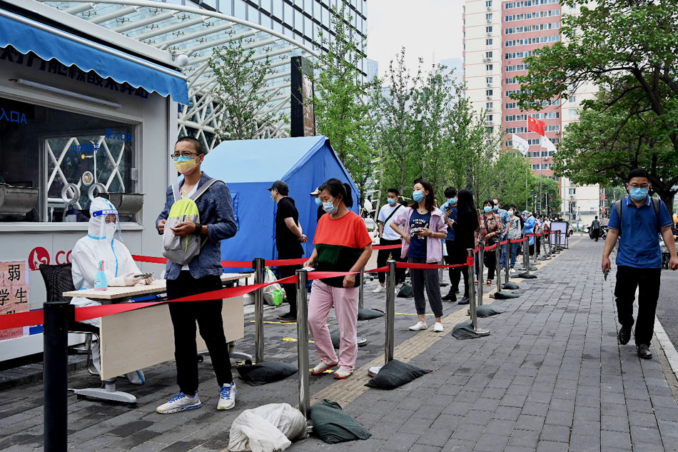 People queue to be tested for the COVID-19 coronavirus at a swab collection site in Beijing on June 13, 2022. Noel Celis, AFP/File 