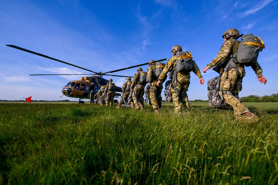 Paratroopers of the Hungarian Army’s 24th Gergely Bornemissza Scout Regiment prepare for a take-off aboard a Mi-17 helicopter during their drill at the airport of Hajduszoboszlo, Hungary, 11 May 2022 (issued 12 May 2022). The paratroopers made their jumps from heights between 500 and 3,000 meters as a tribute to late Staff Sergeant Szabolcs Gal, a member of the Hungarian Armed Forces world champion parachute team, of the 86th Szolnok Helicopter Base. EPA-EFE/Zsolt Czegledi