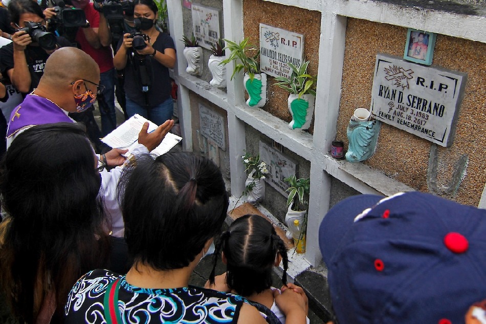 Fr. Flavie Villanueva leads the blessing on the tomb of Kian Delos Santos before the body is exhumed on Monday at the Laloma Cemetery. Delos Santos, 17, was killed by Caloocan police officers during a drug raid five years ago. A local court later convicted three policemen for the murder. Vincent Go, ABS-CBN News