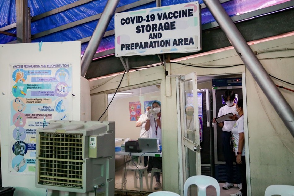 Health workers prepare to administer COVID-19 vaccines at the Cardinal Santos Medical Center vaccination site in San Juan City on June 23, 2022. George Calvelo, ABS-CBN News