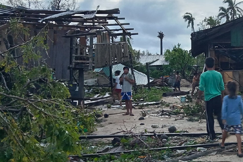 Residents assess damage caused by super typhoon Karding on September 26, 2022, a day after it made landfall in Burdeos, Polillo Islands in Quezon Province. Courtesy of Kevin Morillo