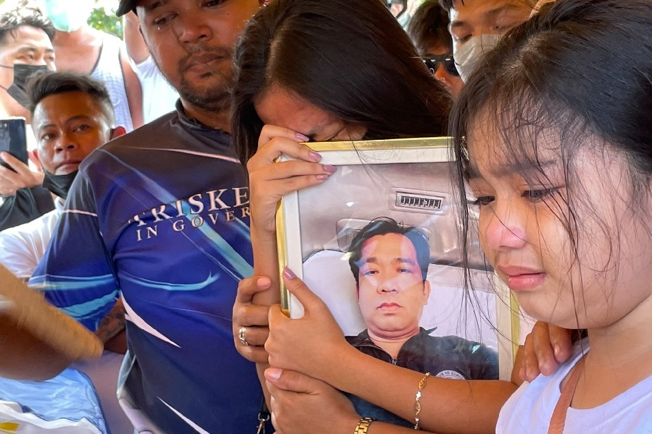 Relatives of George Agustin, one of the 5 Bulacan rescuers who died during Typhoon Karding's onslaught, pay their final tribute to their patriarch before he is laid to rest in the town of Calumpit on Saturday. Katrina Domingo, ABS-CBN News