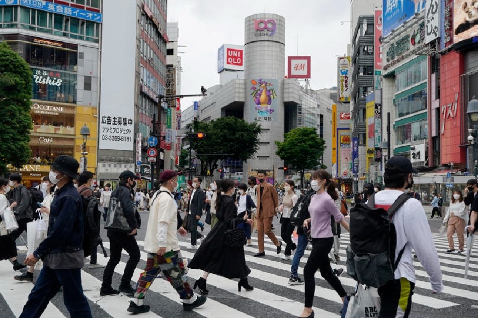 People wearing protective masks walk cross Shibuya scramble crossway in Tokyo, Japan, May 16, 2021. Kimimasa Mayama, EPA-EFE/File