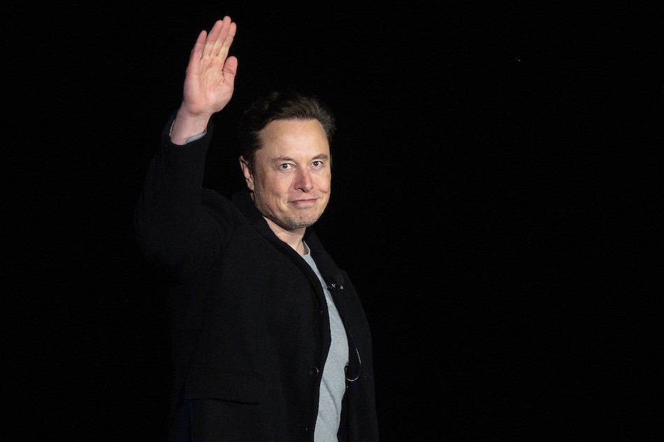  Elon Musk gestures as he speaks during a press conference at SpaceX