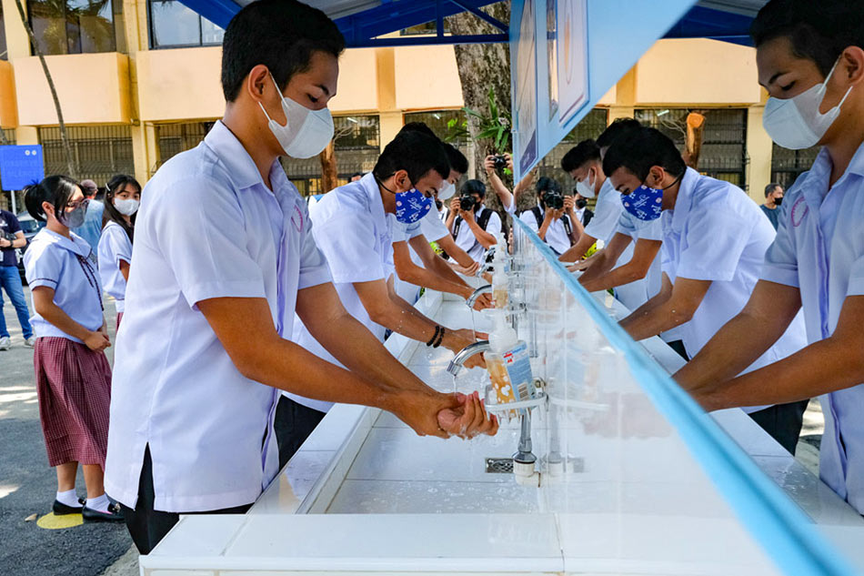 Students demonstrate the proper washing of hands during a school tour at the launch of the “Oplan Kalusugan (OK) sa DepEd at Pinatatag na Healthy Learning Institutions (HLI)” at the Quirino High School in Quezon City on October 11, 2022. George Calvelo, ABS-CBN News/File