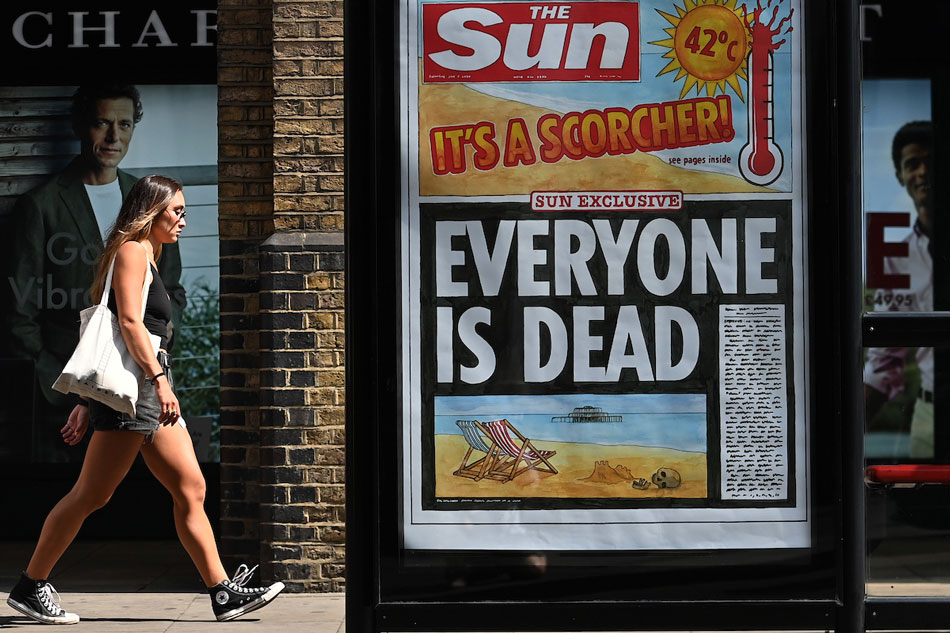 A pedestrian walks past a newspaper headline highlighting the extreme heat in London, Britain on July 20, 2022. The United Kingdom has seen temperatures reach over 40C during the heatwave that has spread from southern Europe, with authorities saying over 1,000 lives have been claimed so far. Andy Rain, EPA-EFE/File 