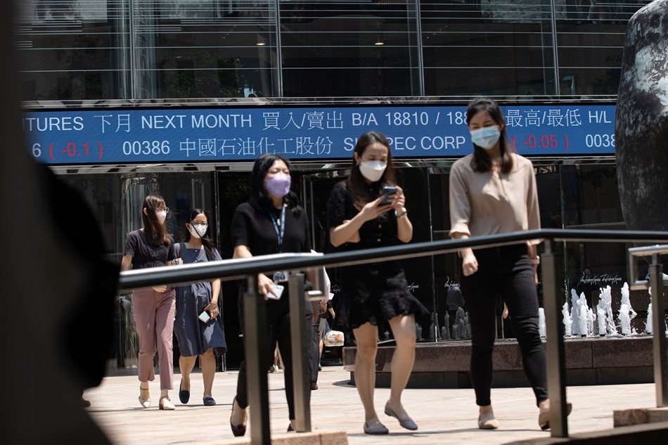 People walk past Exchange Square, the building housing the stock market in Hong Kong, China, Sept. 14, 2022. Hong Kong stocks kicked off on 14 September by losing ground and dropped more than two percent. Jerome Favre, EPA-EFE/File 