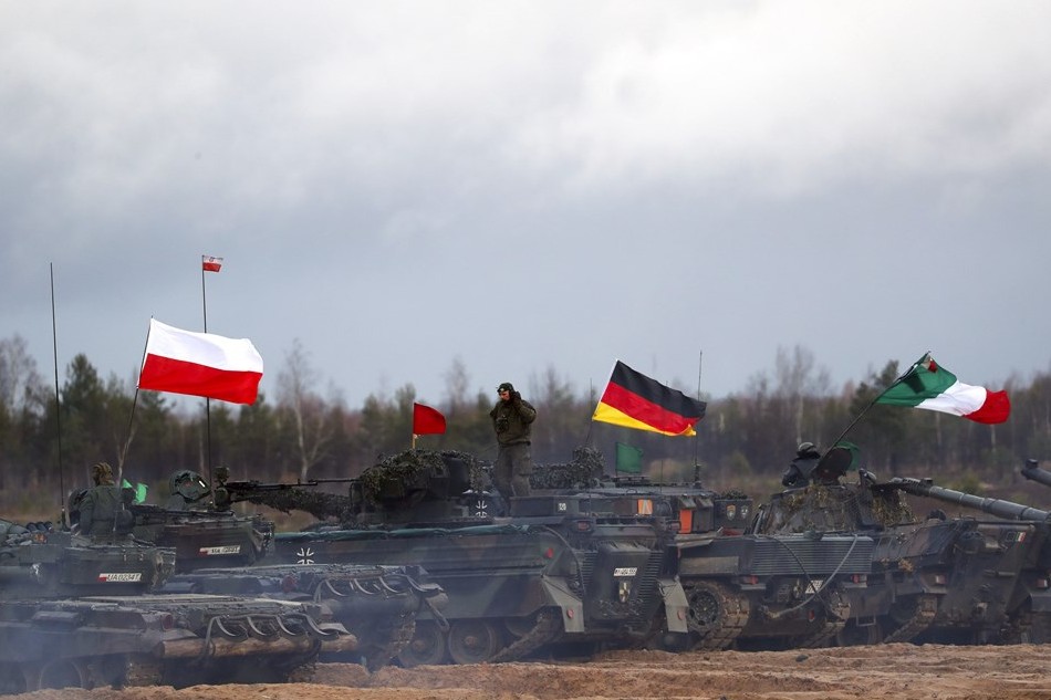 Polish (L), German and Italian (R) servicemen with their armored vehicles attend the fire training during the military exercise 'Iron Spear', in Adazi military base, Latvia, on November 15, 2022. Toms Kalnins, EPA-EFE
