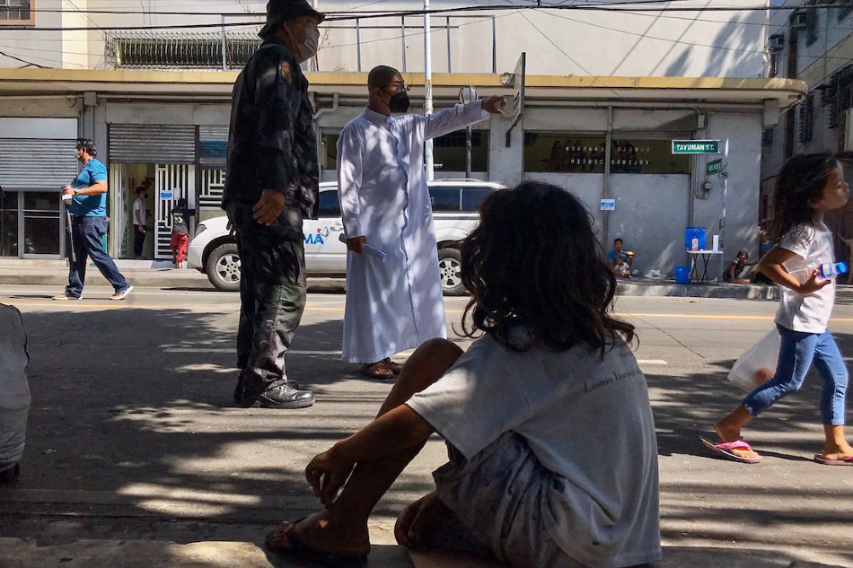 Fr. Flavie Villanueva, head of the Arnold Janssen Kalinga Center in Sta. Cruz Manila, negotiates with police to allow the center to receive beggars and the homeless for their feeding and care program on March 21, 2020. Jonathan Cellona, ABS-CBN News/file