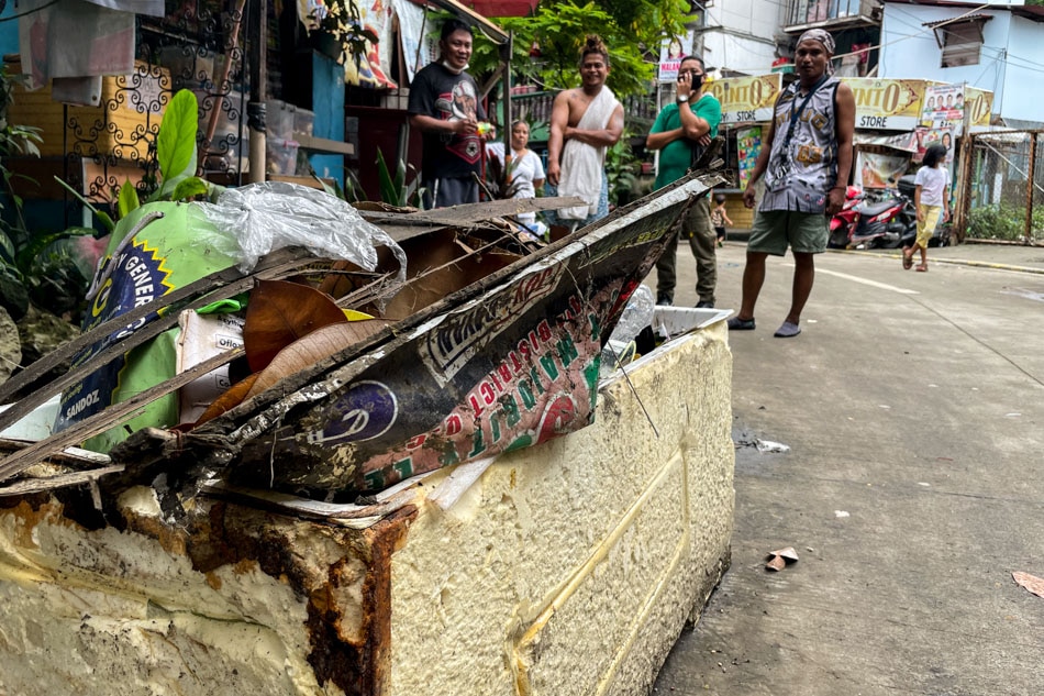 Residents stare at a pile of debris and trash collected after severe flooding caused by heavy rainfall last July 16, 2022. Among the most commonly collected items are election tarpaulins which, according to residents, may have been improperly discarded after the polls. Rafael Bosano, ABS-CBN News