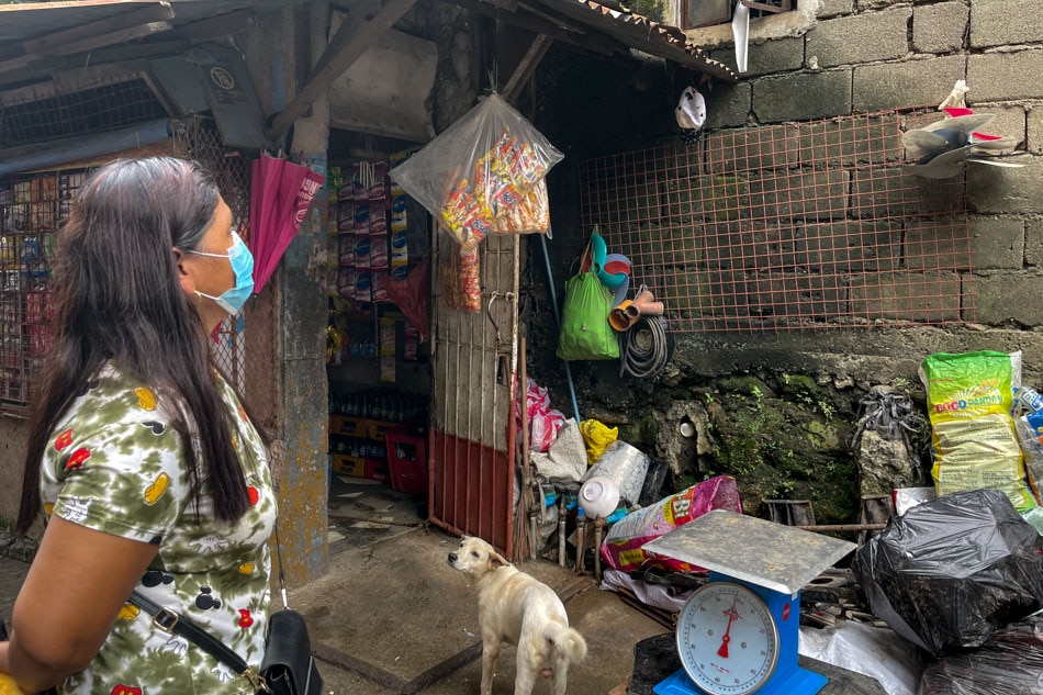 Cynthia Ludovice checks the waste segration as as she goes around the houses previously flooded on Gumamela Street in Barangay Roxas District, Quezon City. Rafael Bosano, ABS-CBN News
