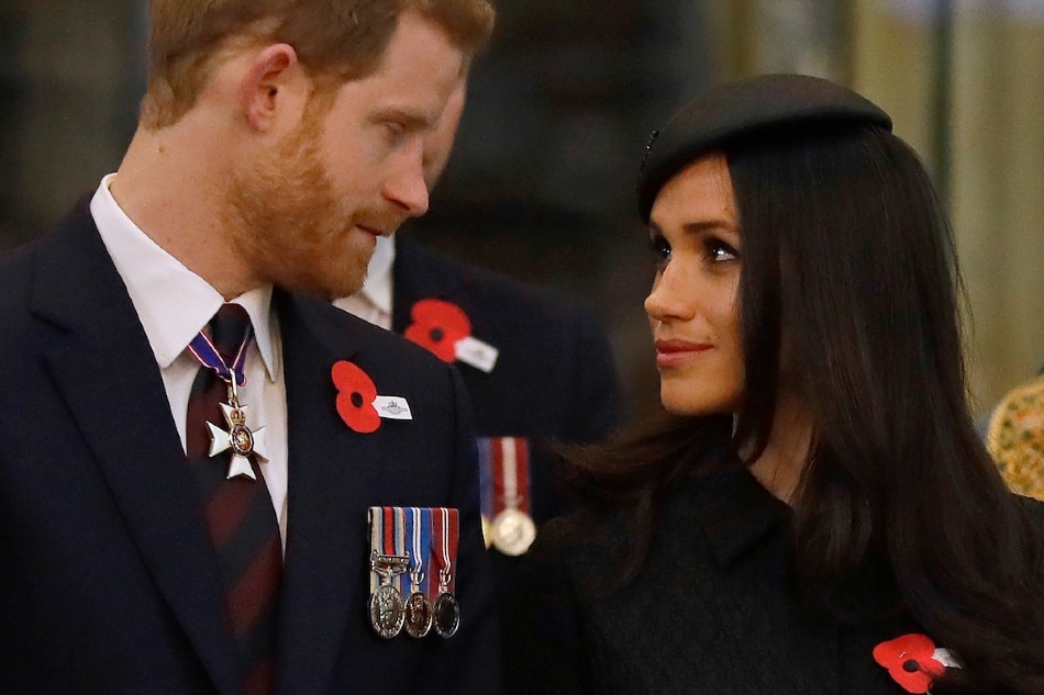  Britain's Prince Harry (L) and Meghan Markle attend a service of commemoration and thanksgiving to mark Anzac Day in Westminster Abbey in London on April 25, 2018. Kirsty Wigglesworth, Pool/AFP