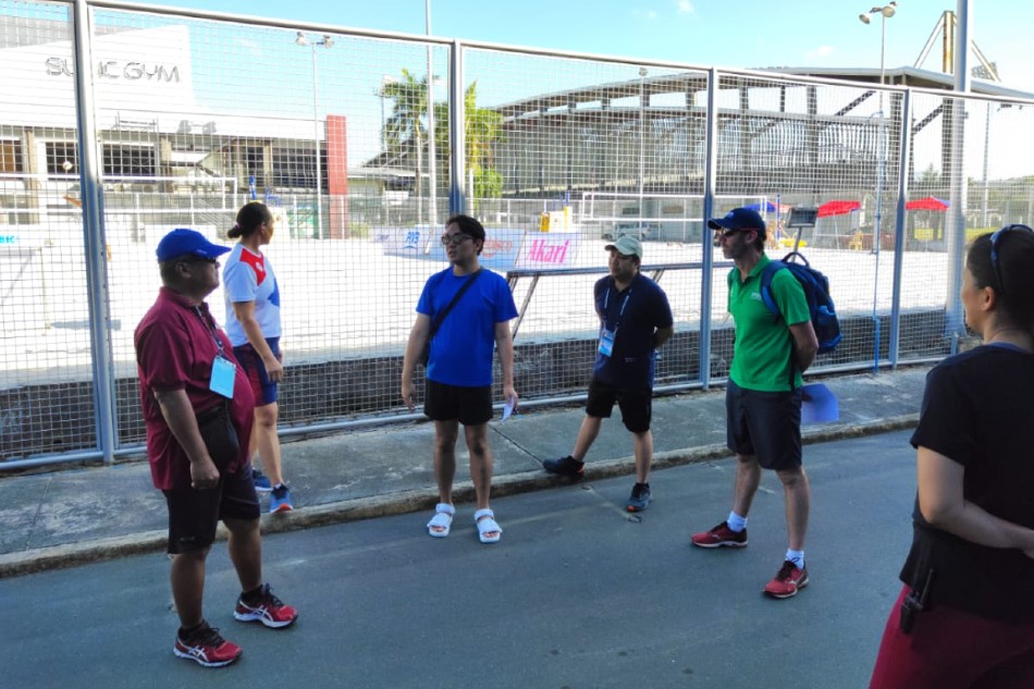 Technical delegate Barry 'Baz' Wedmaier (green polo shirt) of Australia scrutinizes the Subic Bay Sand Court with (from left) competition director Adrian Tabanag, tournament director Mayi Molit-Prochina, administrative director Antonio Carlos, venue director Engineer Joseph Remollena and venue manager Cherry Rose Macatangay. Handout photo.
