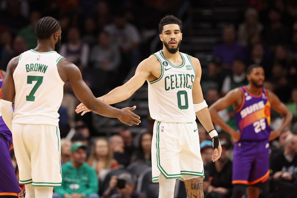 Jayson Tatum #0 of the Boston Celtics high fives Jaylen Brown #7 after scoring against the Phoenix Suns during the second half of the NBA game at Footprint Center on December 07, 2022 in Phoenix, Arizona. Christian Petersen, Getty Images/AFP