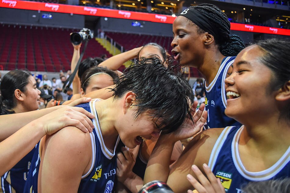 NU captain Mikka Cacho celebrates with her teammates after winning the UAAP Season 85 women's basketball championship. 