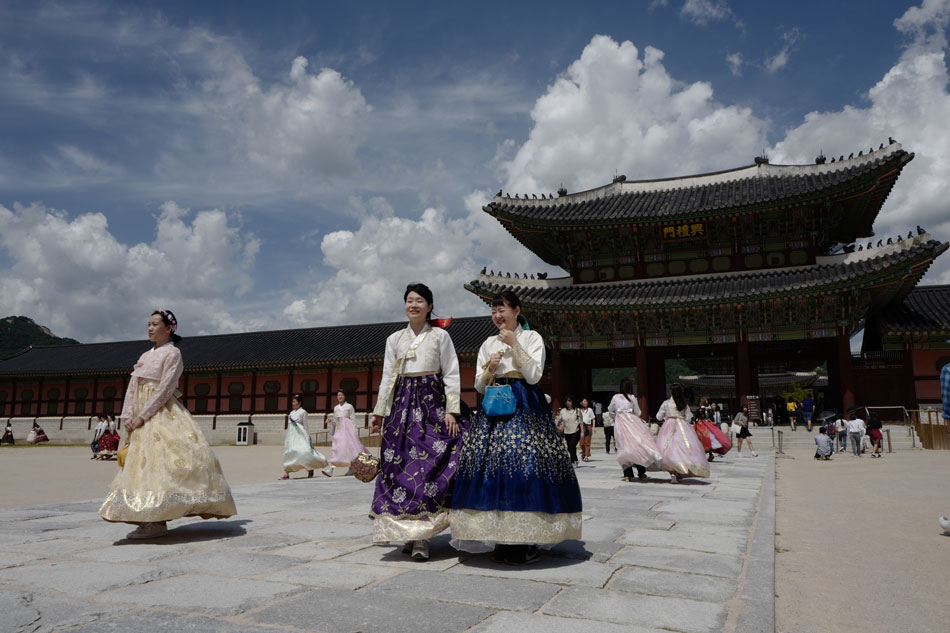 Tourists wearing the traditional 'Hanbok' Korean costume walk during a tour at the Gyeongbok Palace in downtown in Seoul, South Korea, Sept. 5, 2018. Jeon Heon-Kyun, EPA-EFE/File