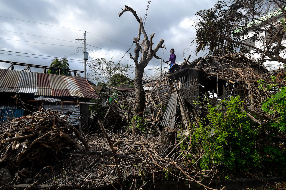 A resident clears out debris in a home in Barangay San Francisco, Anini-y, Antique on December 28, 2021. Mark Demayo, ABS-CBN News