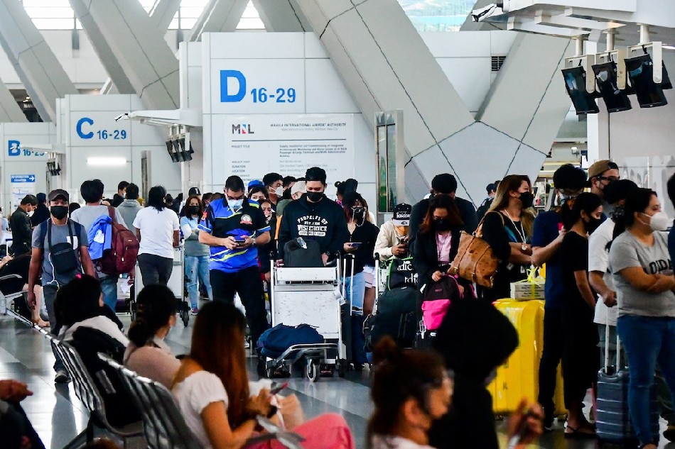 Passengers check in for a flight at the Ninoy Aquino International Airport Terminal 3 in Pasay City on January 3, 2022 amid the imposition of Alert Level 3 in Metro Manila. The capital region was placed under the said alert status due to the jump in COVID-19 cases since the tail end of December. Mark Demayo, ABS-CBN News