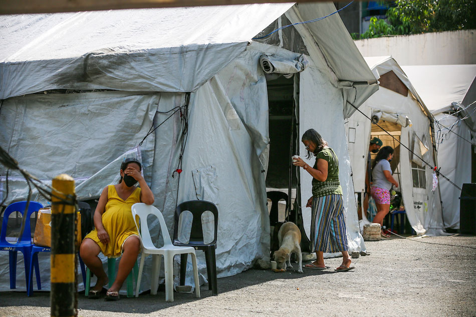 Patients wait by the tents set up as the triage area near the main building of the Sta. Ana Hospital in Manila on January 7, 2022. Jonathan Cellona, ABS-CBN News