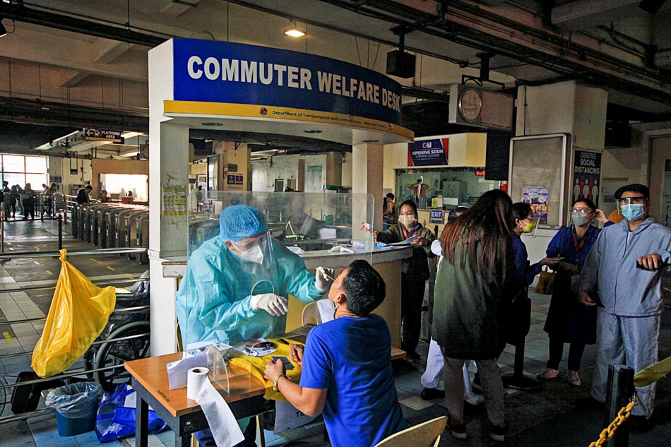 A passenger undergoes a COVID-19 antigen test at the MRT-3’s EDSA-Taft station on Jan. 11, 2022. ABS-CBN News/file