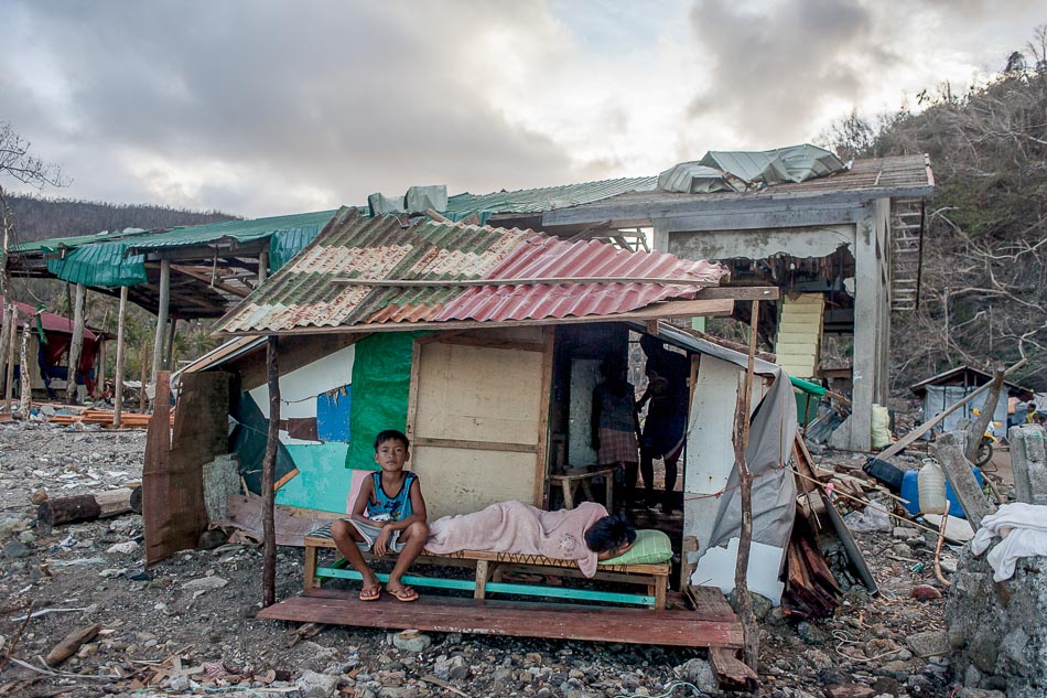 Families build and stay in temporary shelters where their homes once stood in Barangay Boa in Cagdiangao, Dinagat Islands on January 11, 2022, almost a month since Typhoon Odette hit parts of the country leaving billions in damages and more than 400 dead. Leonard Reyes, ABS-CBN News/File