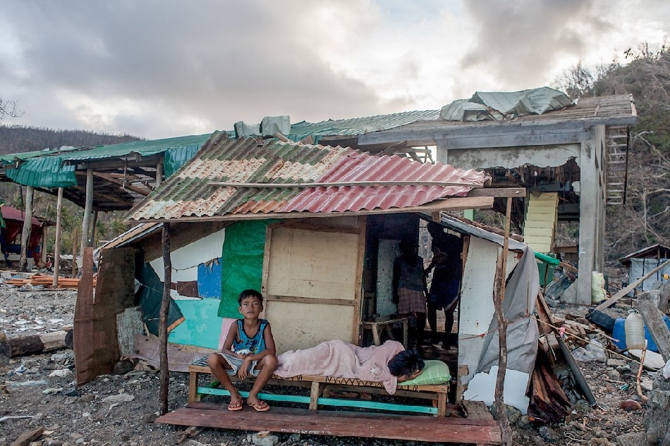Families build and stay in temporary shelters where their homes once stood in Barangay Boa in Cagdiangao, Dinagat Islands on January 11, 2022, almost a month since Typhoon Odette hit parts of the country. Leonard Reyes, ABS-CBN News