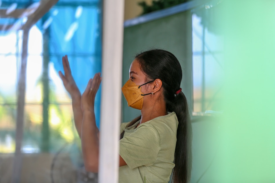 A teacher gives instruction behind a plastic barrier during the first day of limited face-to-face classes at the Longos Elementary School in Barangay Pangapisan in Alaminos City, Pangasinan on November 15, 2021. Jonathan Cellona, ABS-CBN News