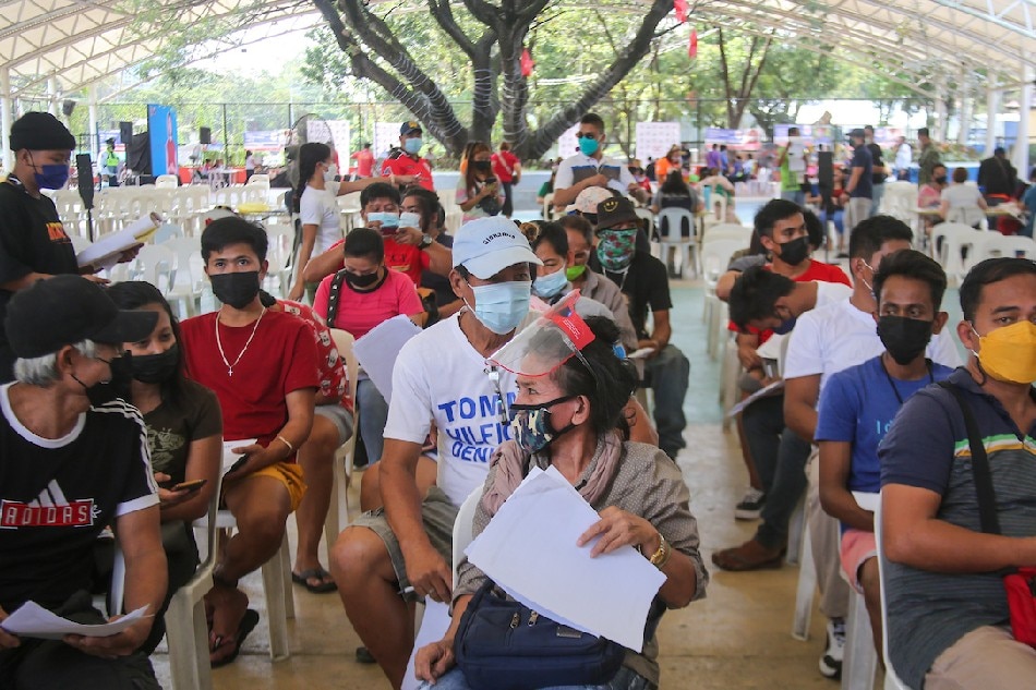 People queue to receive the COVID-19 vaccine at the Quezon Memorial Circle Vaccination Hub in Quezon City on January 18, 2022. Jonathan Cellona, ABS-CBN News/file