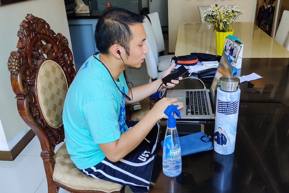 A merchant associate for a financial technology company works from his home in Quezon City on March 18, 2020, amid the enhanced community quarantine for the whole of Luzon. Mark Demayo, ABS-CBN News
