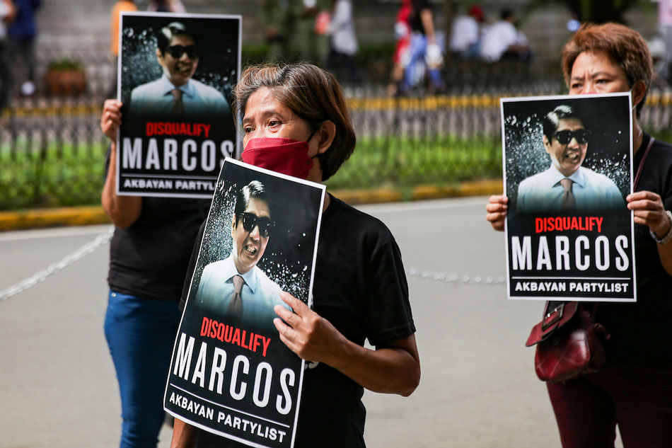 A group consisting of various martial law survivors, led by Akbayan Party List stage a protest in front of the Commission on Elections headquarters in Intramuros, as their leaders filed a new disqualification case against presidential candidate Ferdinand “Bongbong” Marcos Jr. on December 2, 2021. George Calvelo, ABS-CBN News/File