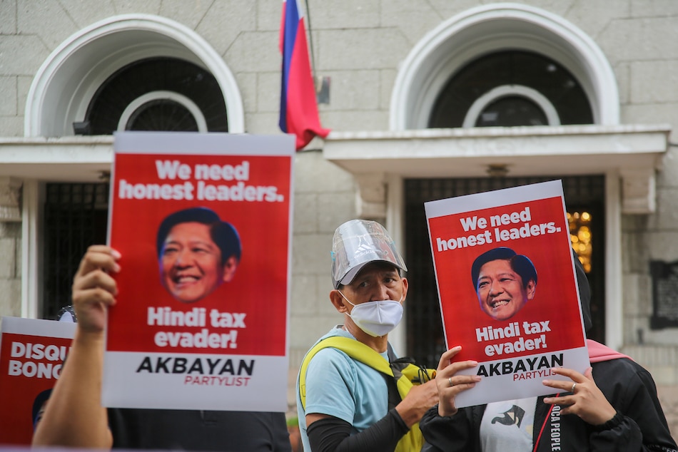 Members of Akbayan party-list hold a protest outside the Commission on Election headquarters on Nov. 4, 2021, calling for the disqualification of presidential candidate Ferdinand 