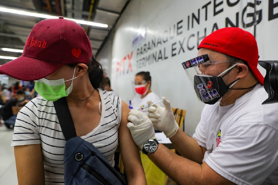 Travelers and transport workers receive their COVID-19 vaccine as the Department of Transportation and the Metro Manila Development Authority launch their mobile vaccination drive at the Parañaque Integrated Terminal Exchange (PITX) on Jan. 24, 2022. Jonathan Cellona, ABS-CBN News