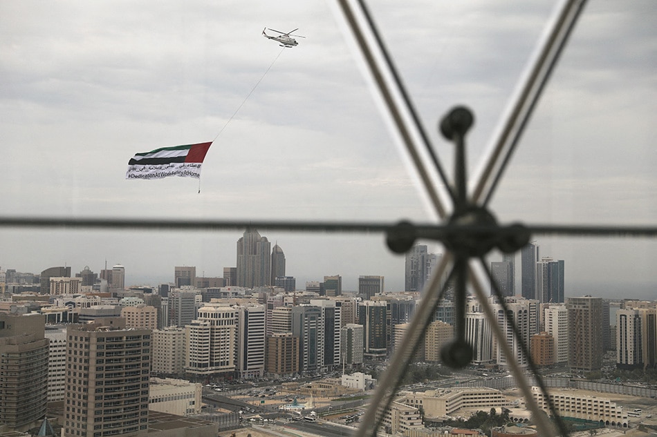 A helicopter flies over the downtown skyline of Abu Dhabi, United Arab Emirates, on April 20, 2020. Christopher Pike, Reuters/File Photo