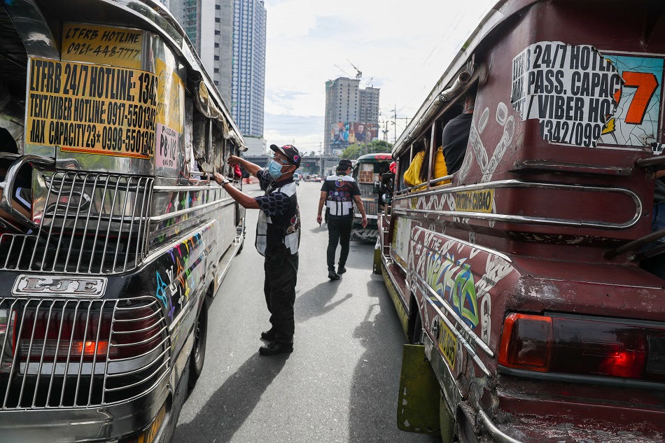 Members of the Inter-Agency Council for Traffic (I-ACT) Special Task Force inspect passing public utility vehicles along Katipunan Avenue in Quezon City on May 10, 2021. Jonathan Cellona, ABS-CBN News/File