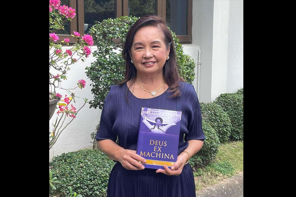 Former Philippine President Gloria Macapagal-Arroyo poses with her book 'Deux Ex Machina' in her Quezon City residence on Wednesday. RG Cruz, ABS-CBN News