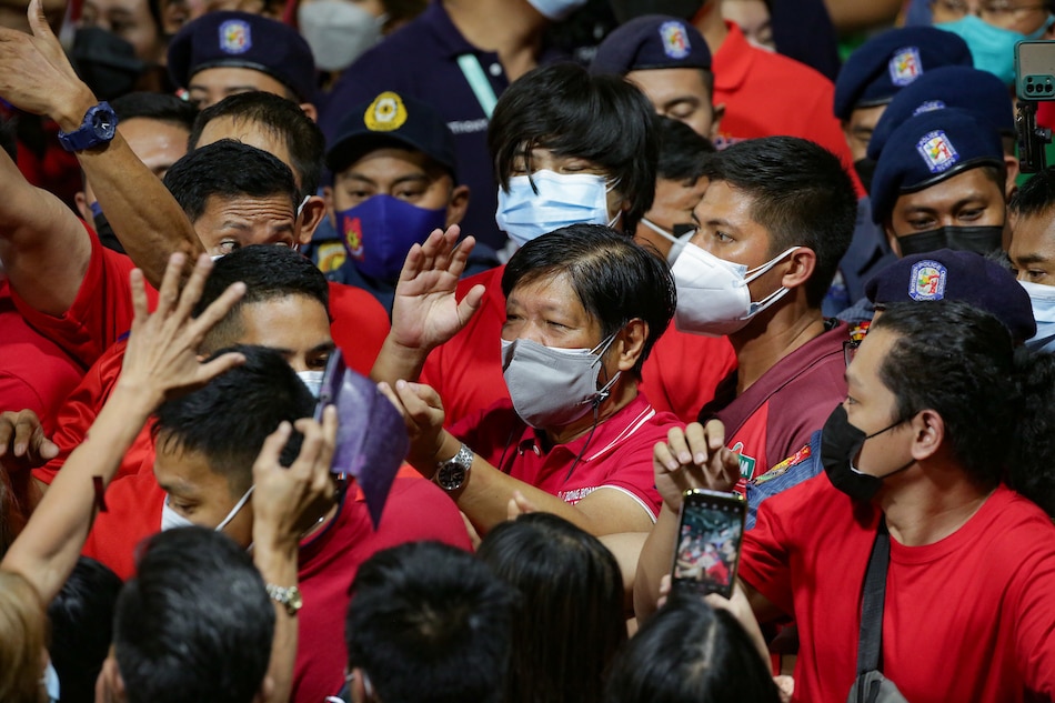 Presidential aspirant Ferdinand “Bongbong” Marcos Jr. is swarmed by supporters as he exits the venue of the “UniTeam” grand rally held at the WES Arena in Punturin, Valenzuela City on February 10, 2022. George Calvelo, ABS-CBN News