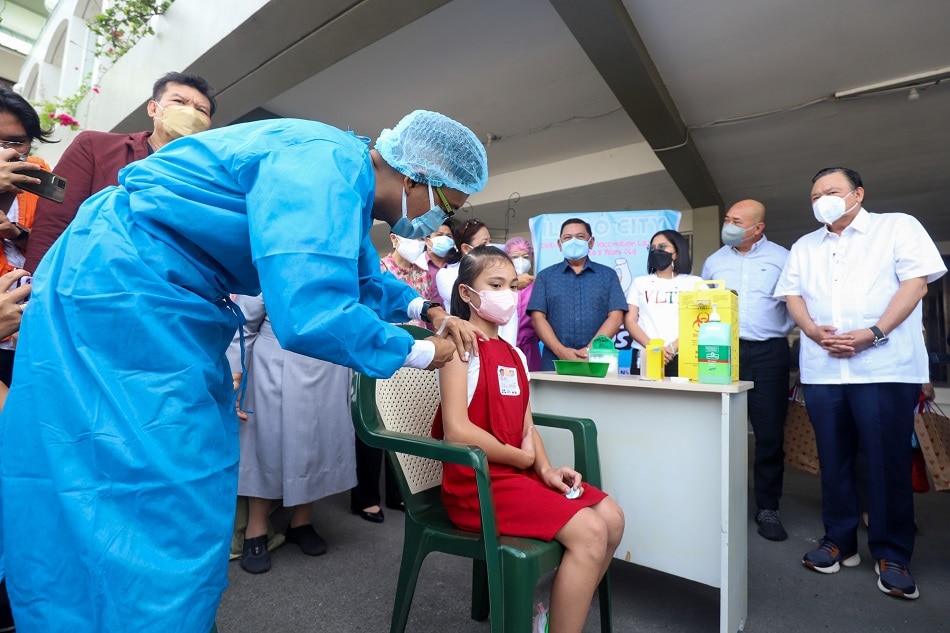 A health worker administers COVID-19 vaccine during the launching of Resbakuna KIDS at St. Paul's Hospital in Iloilo City on February 14, 2022. Arnold Almacen, Iloilo City Mayor's Office