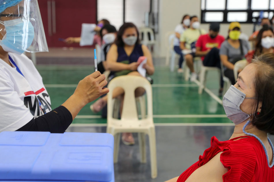 Manila Health Department personnel administer COVID-19 vaccine to faculty and students at the Polytechnic University of the Philippines in Sta. Mesa, Manila on Feb. 11, 2022. Jonathan Cellona, ABS-CBN News/File