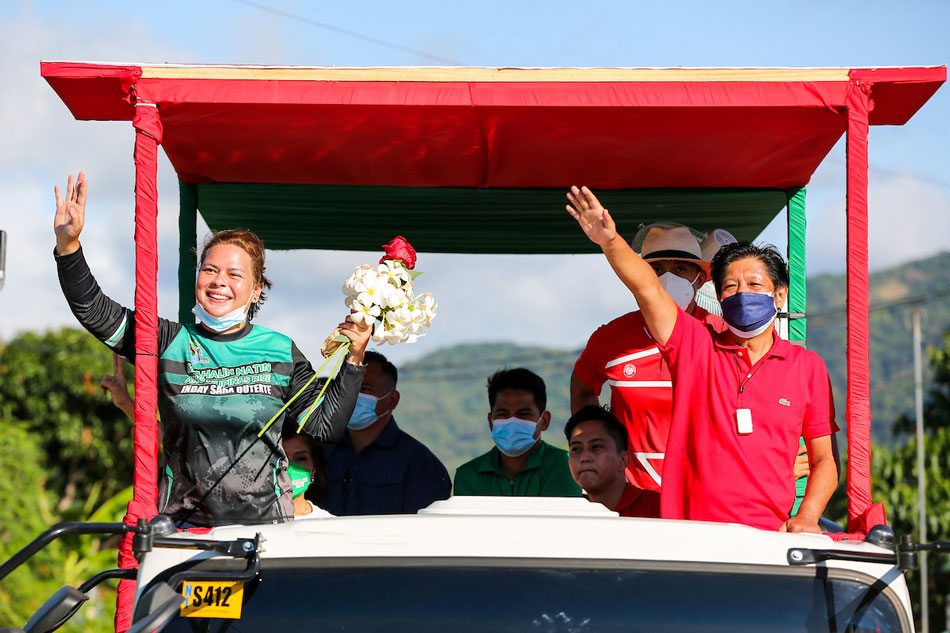  Halalan 2022 presidential hopeful Ferdinand Marcos Jr and running mate Davao City Mayor Sara Duterte greet supporters en route to Pagudpod from Laoag during a campaign caravan in Marcos’ bailiwick Ilocos Norte on Feb. 16, 2022. Jonathan Cellona, ABS-CBN News/File