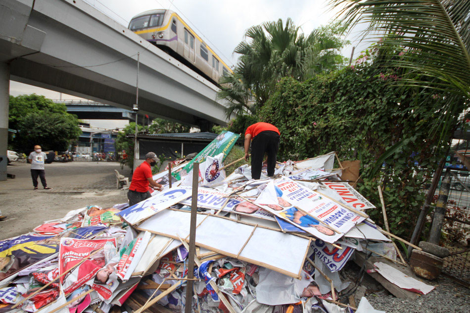 Members of the Metro Manila Development Authority collect dismantled campaign posters and tarpaulins at the MMDA satellite office in Sta. Mesa, Manila during 