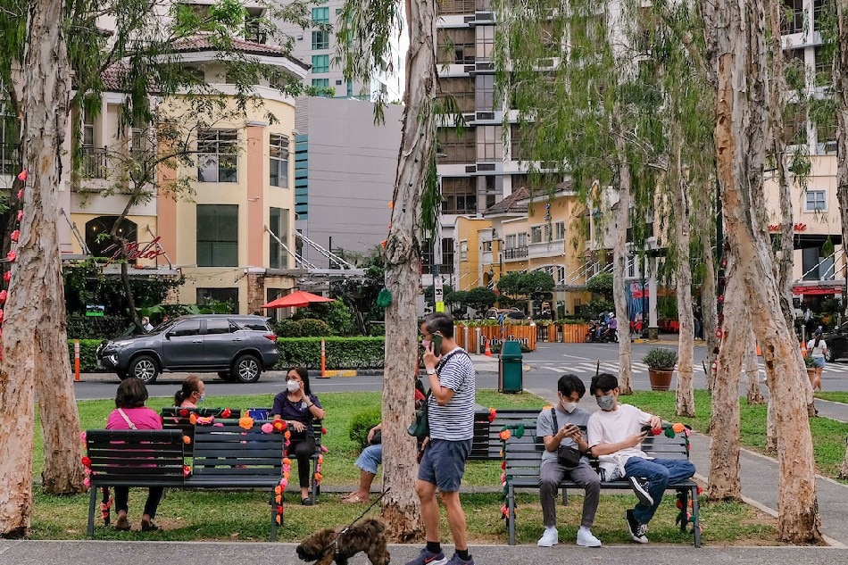 People spend time outdoors at a park in Bonifacio Global City in Taguig on February 15, 2022. George Calvelo, ABS-CBN News
