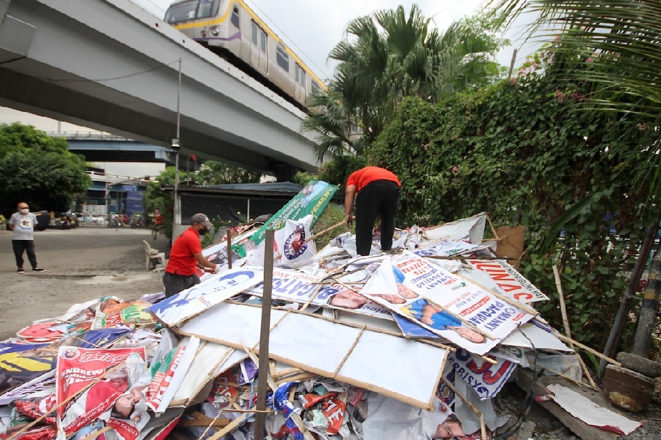 : Members of the Metro Manila Development Authority collect dismantled campaign posters and tarpaulins at the MMDA satellite office in Sta. Mesa, Manila during the ongoing 