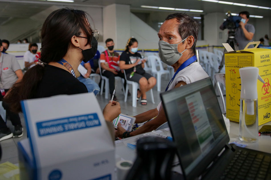 A man gets vaccinated at the Recto Station of LRT-2 in Manila on February 22, 2022. George Calvelo, ABS-CBN News/File